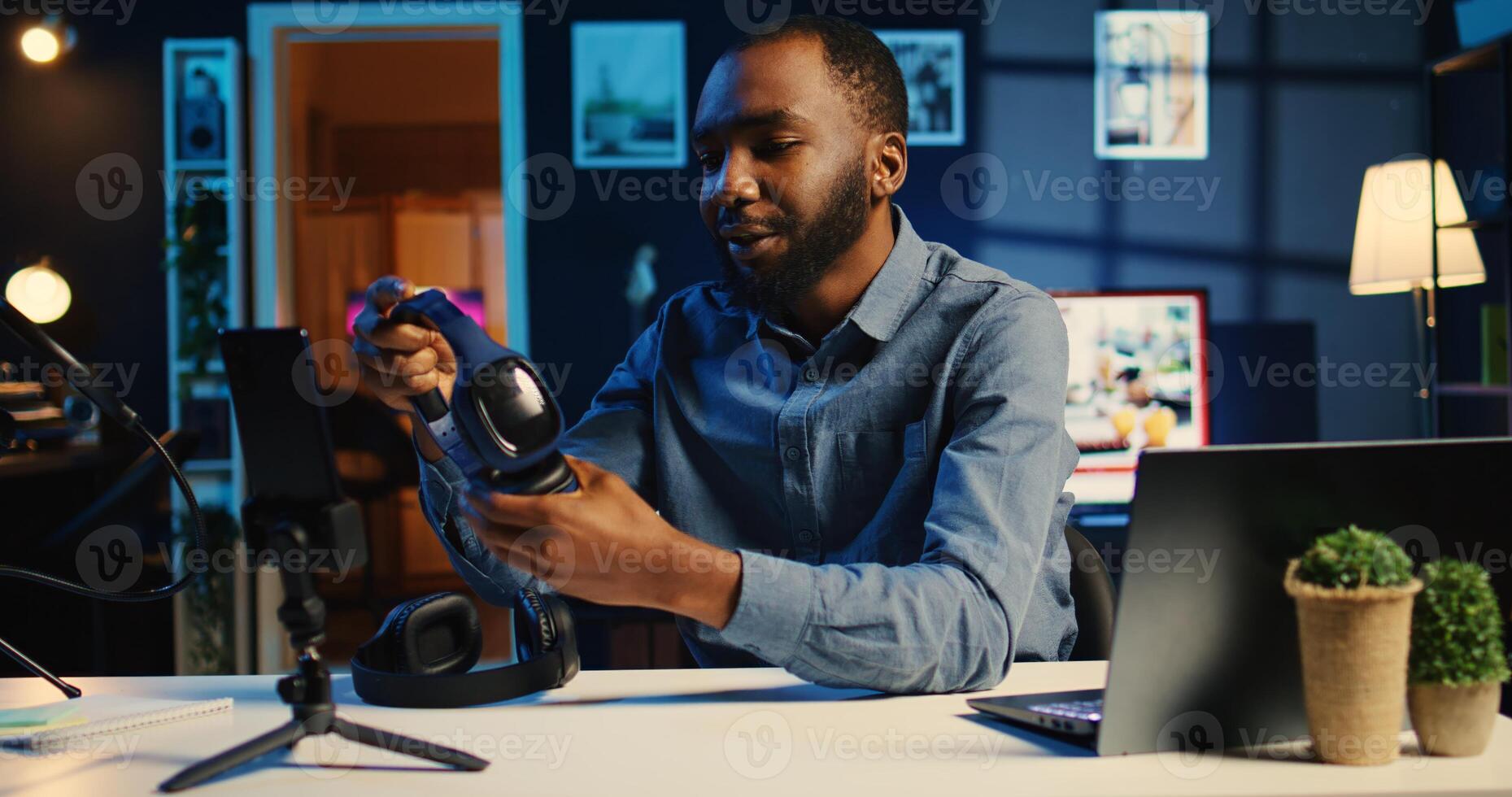 Tech influencer filming review of noise cancelling headphones comparison between two pairs, giving feedback on best performing one, recording with professional equipment photo