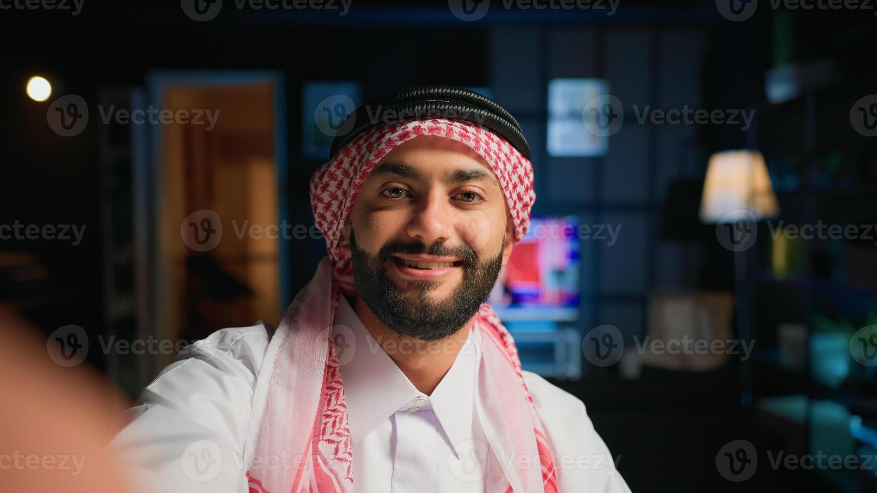 Point of view shot of arab content creator using smartphone to do live broadcast for subscribers, showing his home studio. Middle Eastern online star films himself using cellphone camera, POV photo