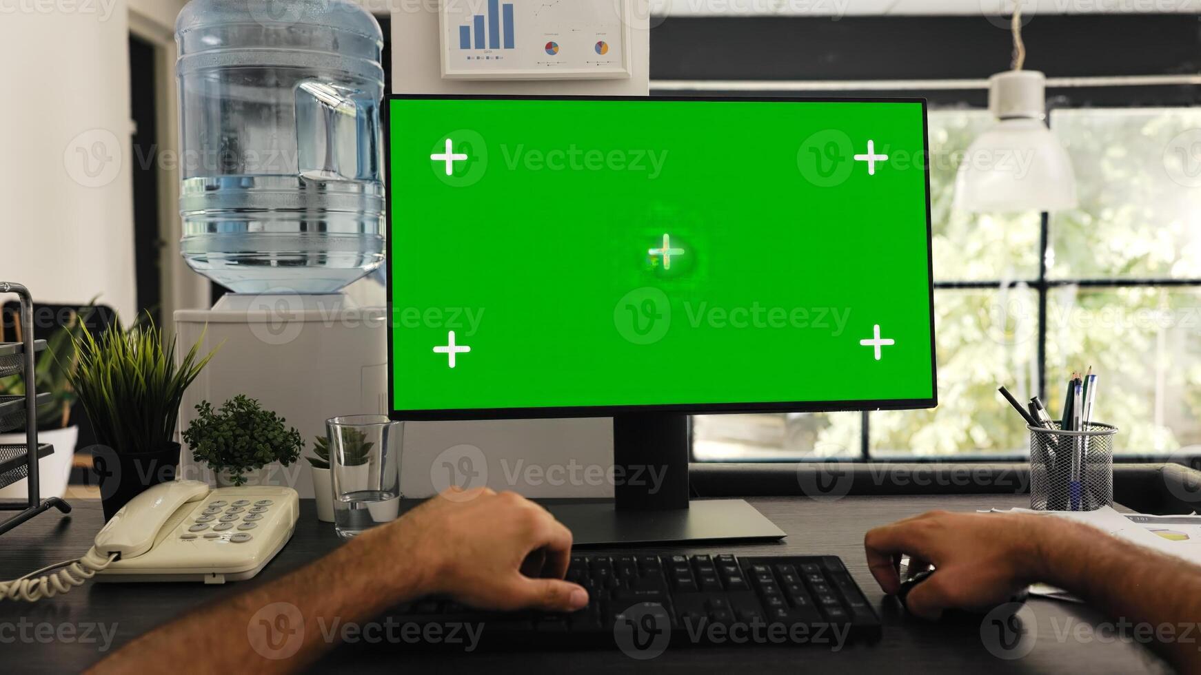 POV of man at desk works with greenscreen and isolated copyspace template, solving business tasks. Company manager sitting at workstation looking at blank chromakey screen. Tripod shot. photo