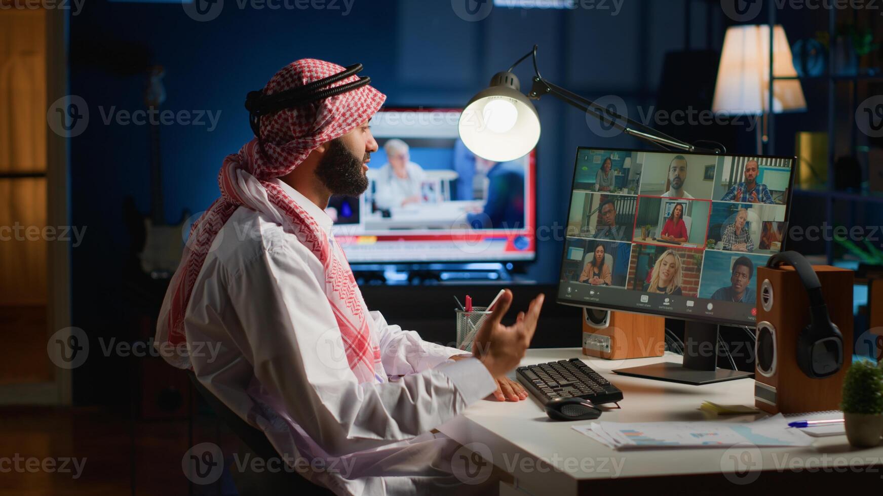 Muslim team leader holding online conference meeting with remotely working subalterns, checking on task progress. Middle Eastern business executive discussing with employees during call photo