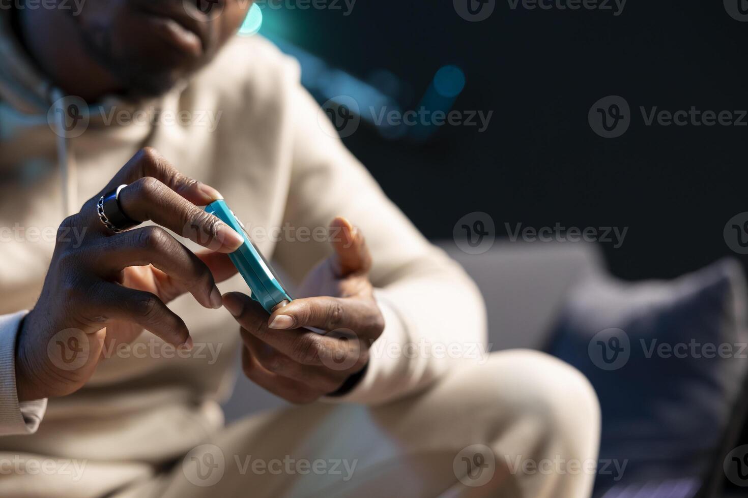 Close up shot of pulse oximeter used by man to monitor level of blood oxygen saturation and heart rate. Focus on medical instrument used by person in blurry background doing annual checkup at home photo