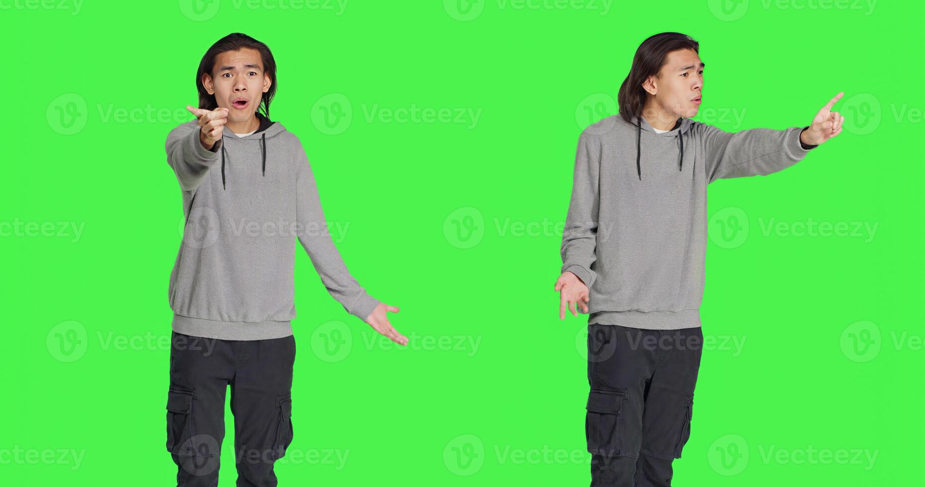 Young man showing no gesture in studio, expressing negativity and disagreement over isolated greenscreen backdrop. Asian male model being disappointed and disapproving with something. photo