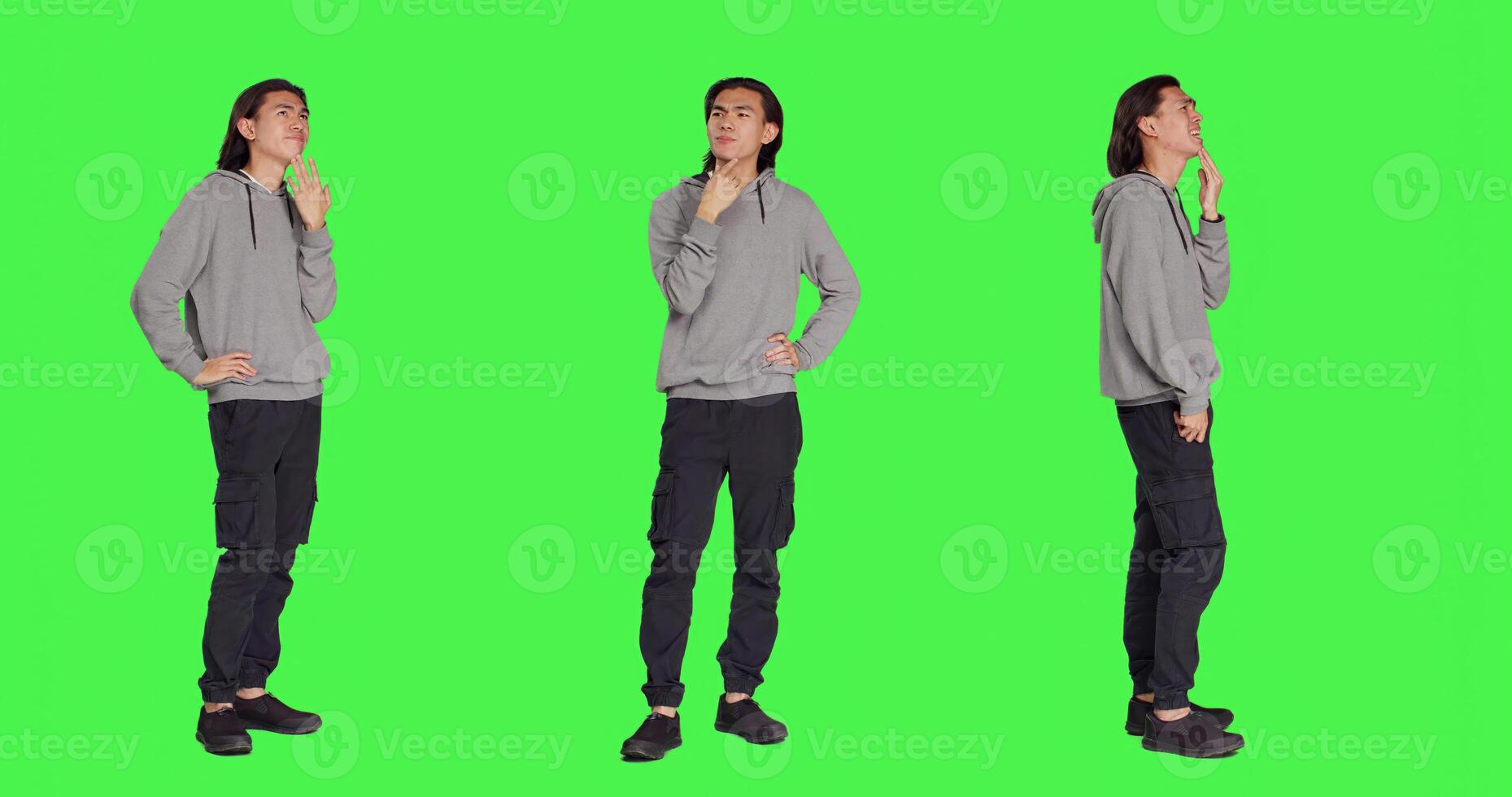 Asian adult questioning perspective standing in greenscreen studio, thinking about answer and pondering solution. Person being in a dilemma trying to focus, pensive unsure adult thinker. photo