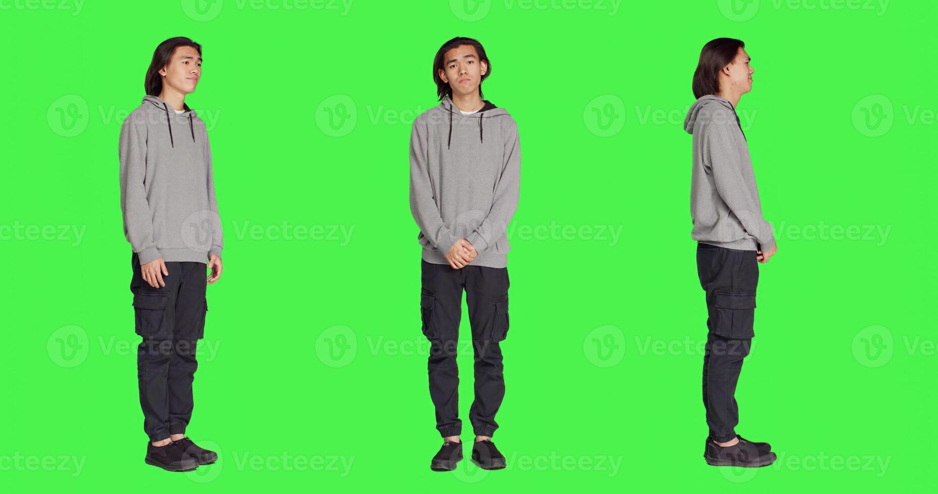 Young model doing no sign on camera, expressing negativity and disagreement over blank greenscreen backdrop. Asian person being displeased and disapproving with something, denial. photo