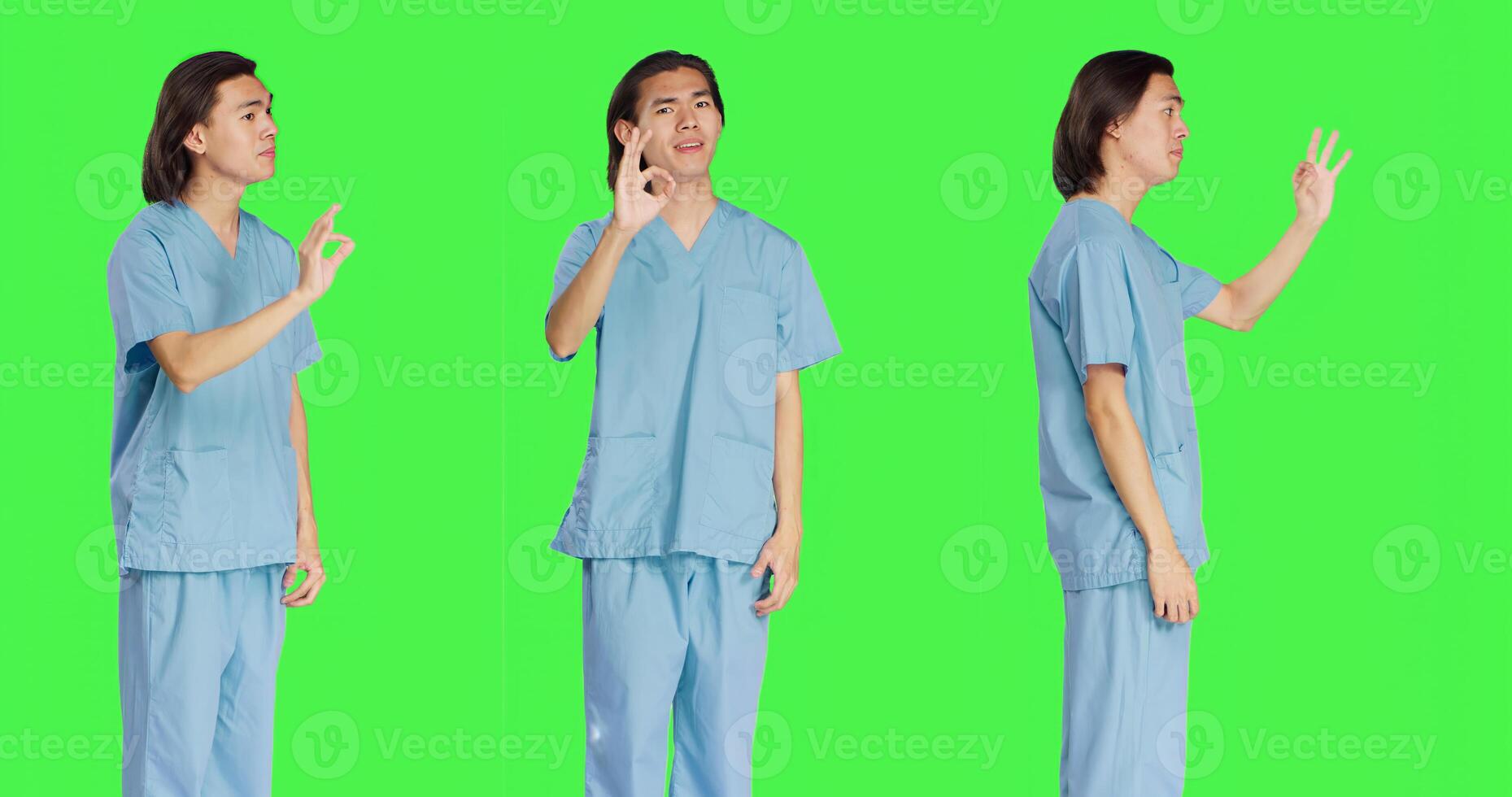Medical specialist presents okay gesture over greenscreen backdrop, showing approval and like symbol. Healthcare worker in uniform doing agreement sign standing in studio. photo