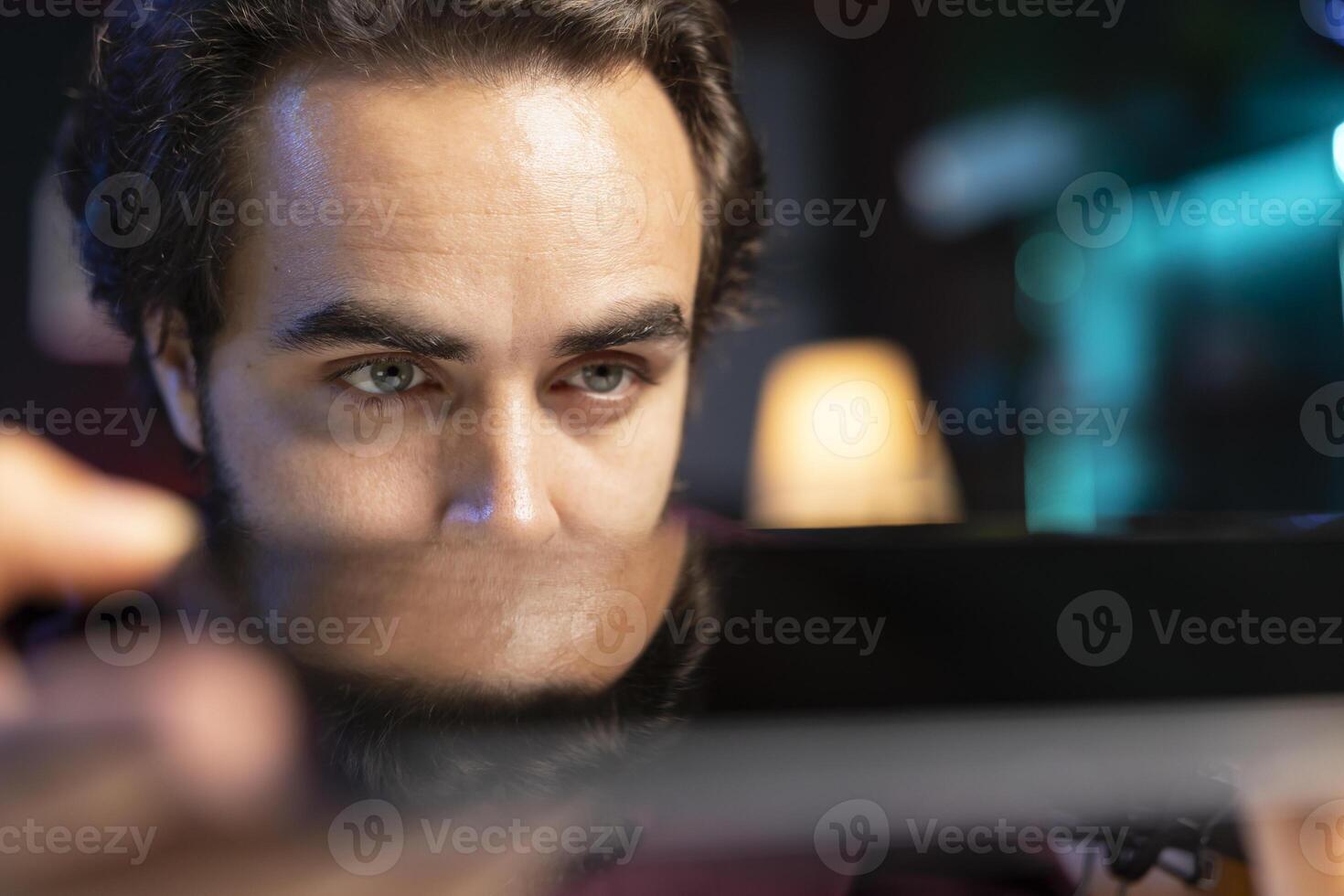 Close up shot of sleek tablet reviewed by influencer in home studio. Viral media star hosts technology internet show, analyzing digital portable device, feeling impressed by thinness photo