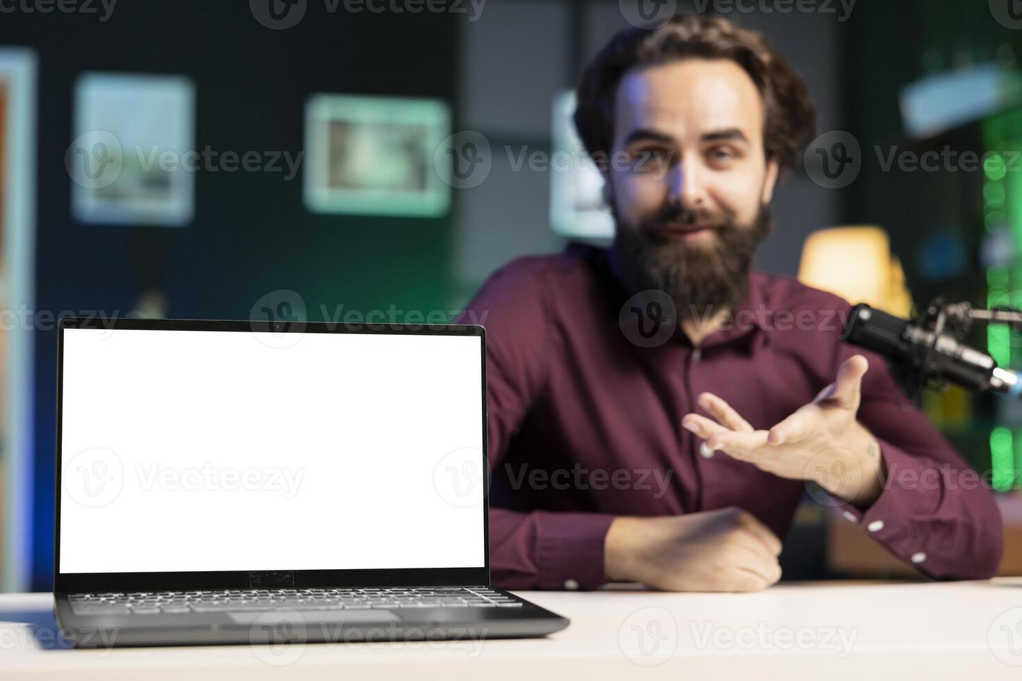 Close up shot of mockup laptop being assessed by cheerful tech expert talking about parts used inside. Focus on isolated screen notebook reviewed by man in blurry background for technology channel photo