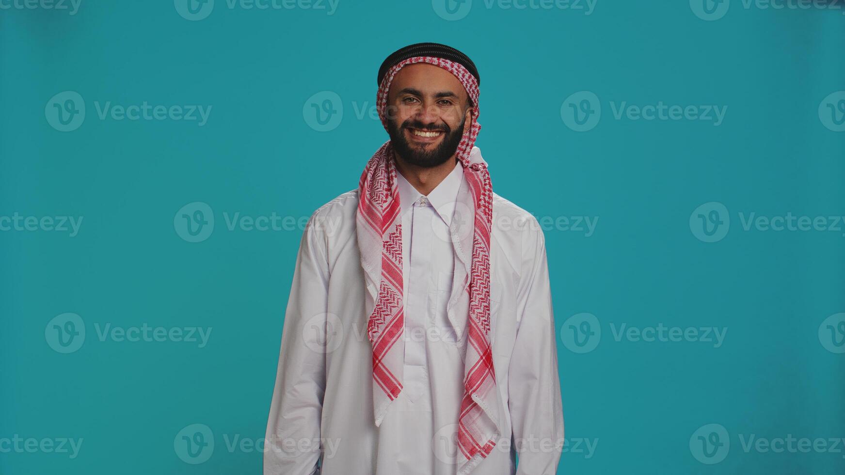 Arab person says yes and nodding on camera, presenting agreement and support about something. Middle eastern man expressing positivity and confidence, showing agreement. photo