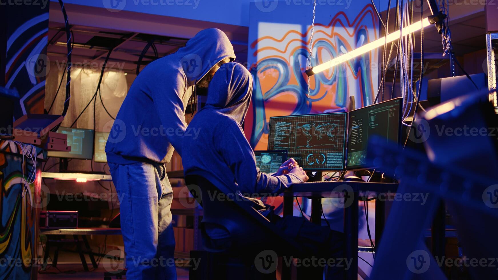 Spies in secret hideaway doing valuable data theft by hacking governmental websites with weak security. Cybercriminals using extensive technology knowledge to access valuable information illegally photo
