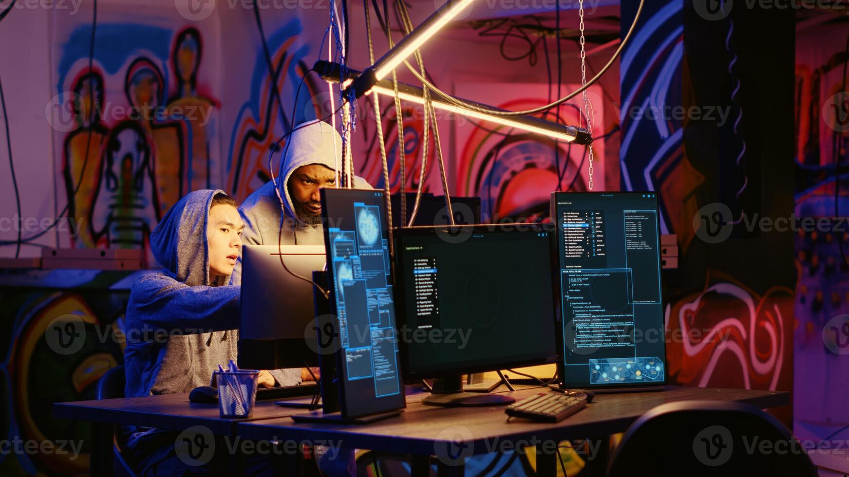 Hackers in dark room discussing ways to breach defenses and exploit weaknesses in PC systems. Evil computer scientists in hidden base getting past companies security networks photo