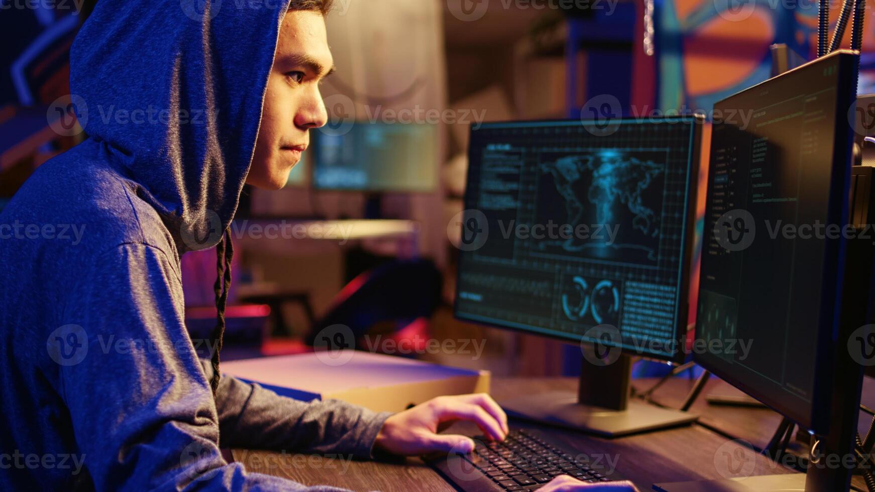 Asian hacker doing international espionage warfare for his government to steal state secrets from another countries, anxiously looking over shoulder, afraid of being caught and going to jail photo