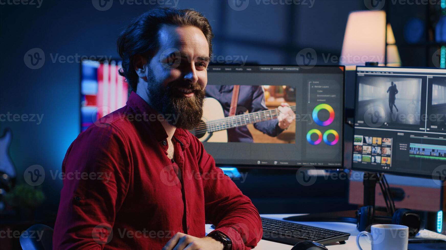 Happy videographer reviewing footage and selecting scenes, trimming them using specialized software applications and editing tools. Smiling editor working for media company in editing room photo