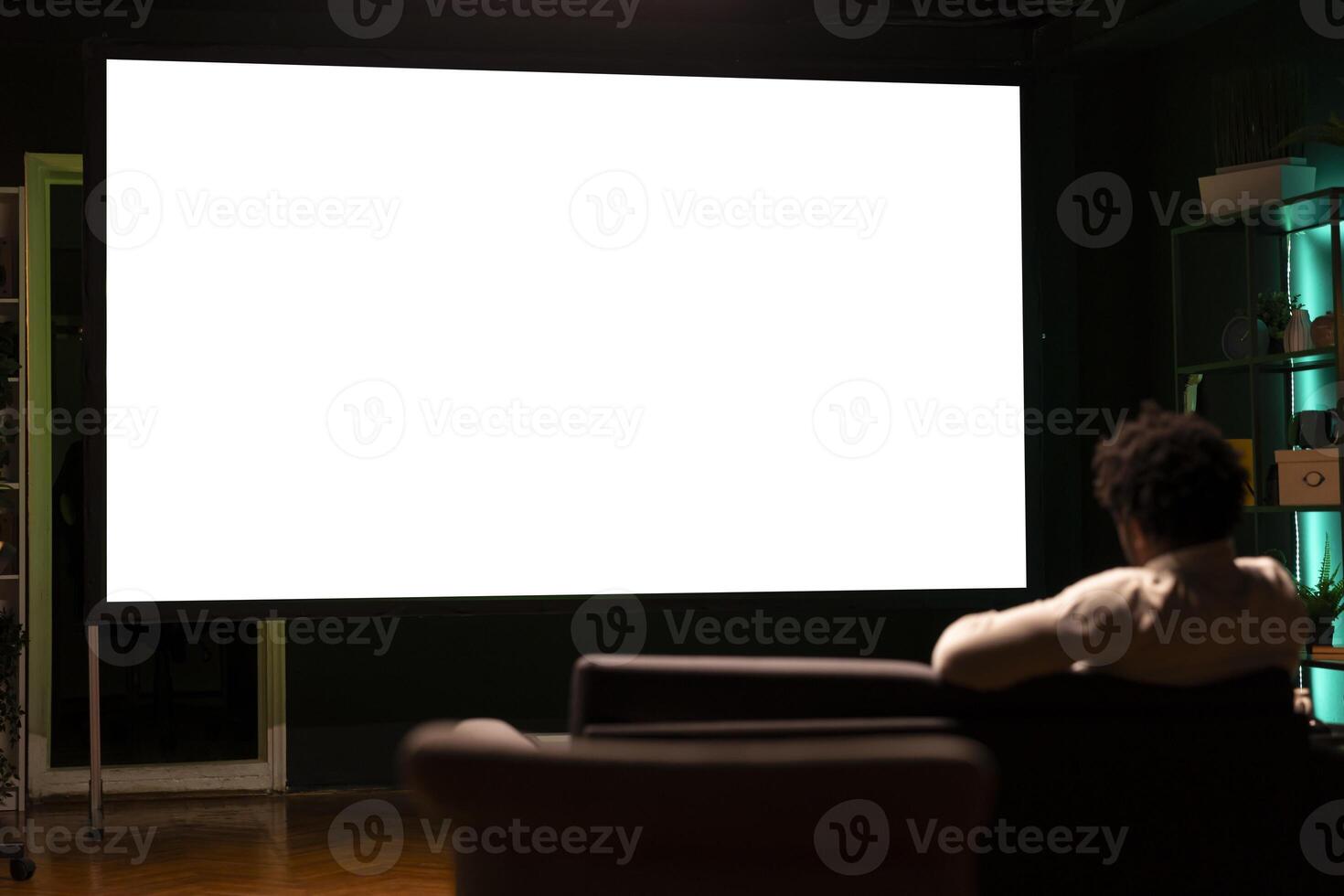Person using isolated screen ultrawide smart TV to binge series on subscription based streaming services. African american man relaxing, enjoying on demand shows on mockup television display photo