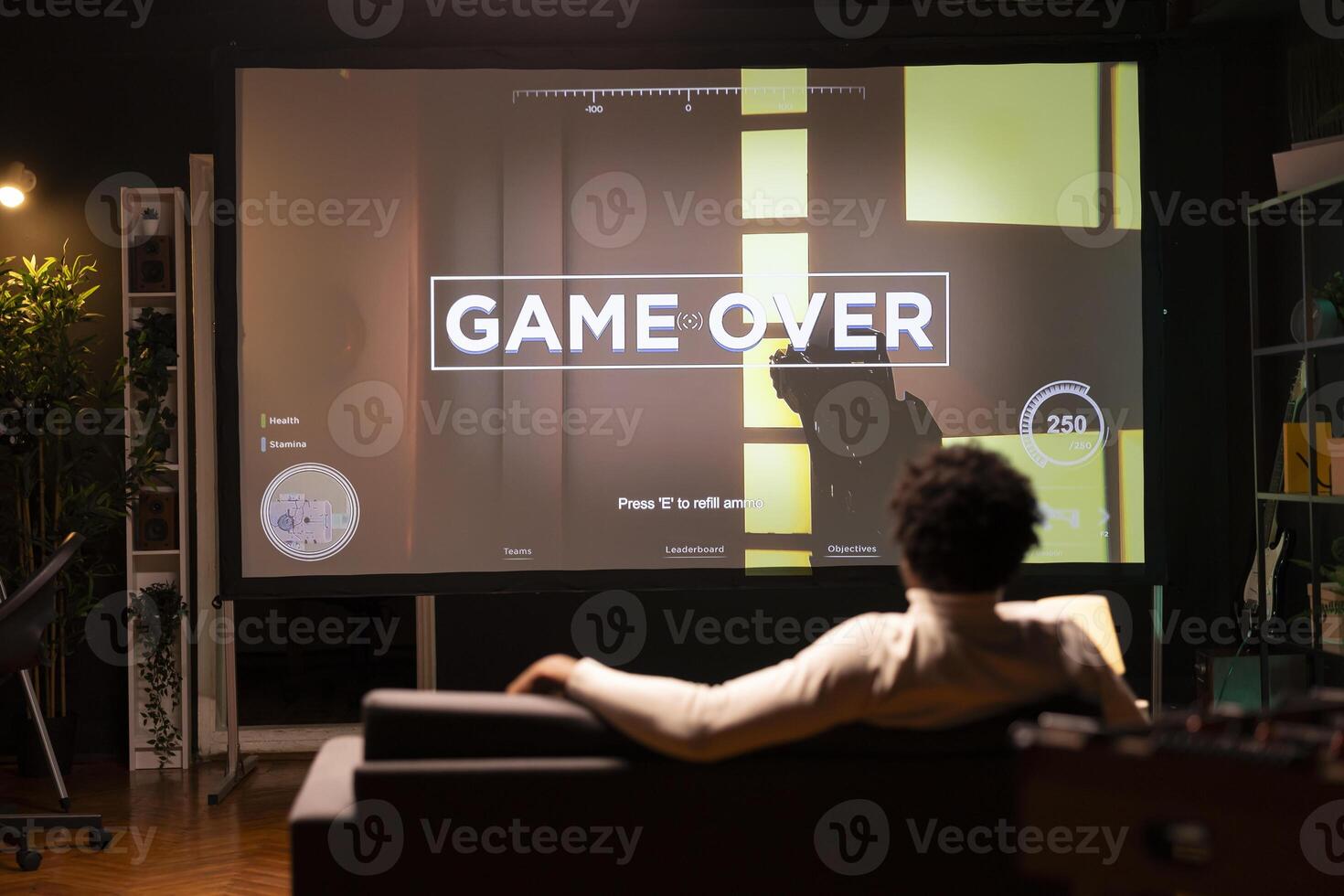Man seeing livestream footage on ultrawide smart TV display from content creator losing videogame. African american gamer sitting at home and seeing pro streamer being defeated in esports competition photo