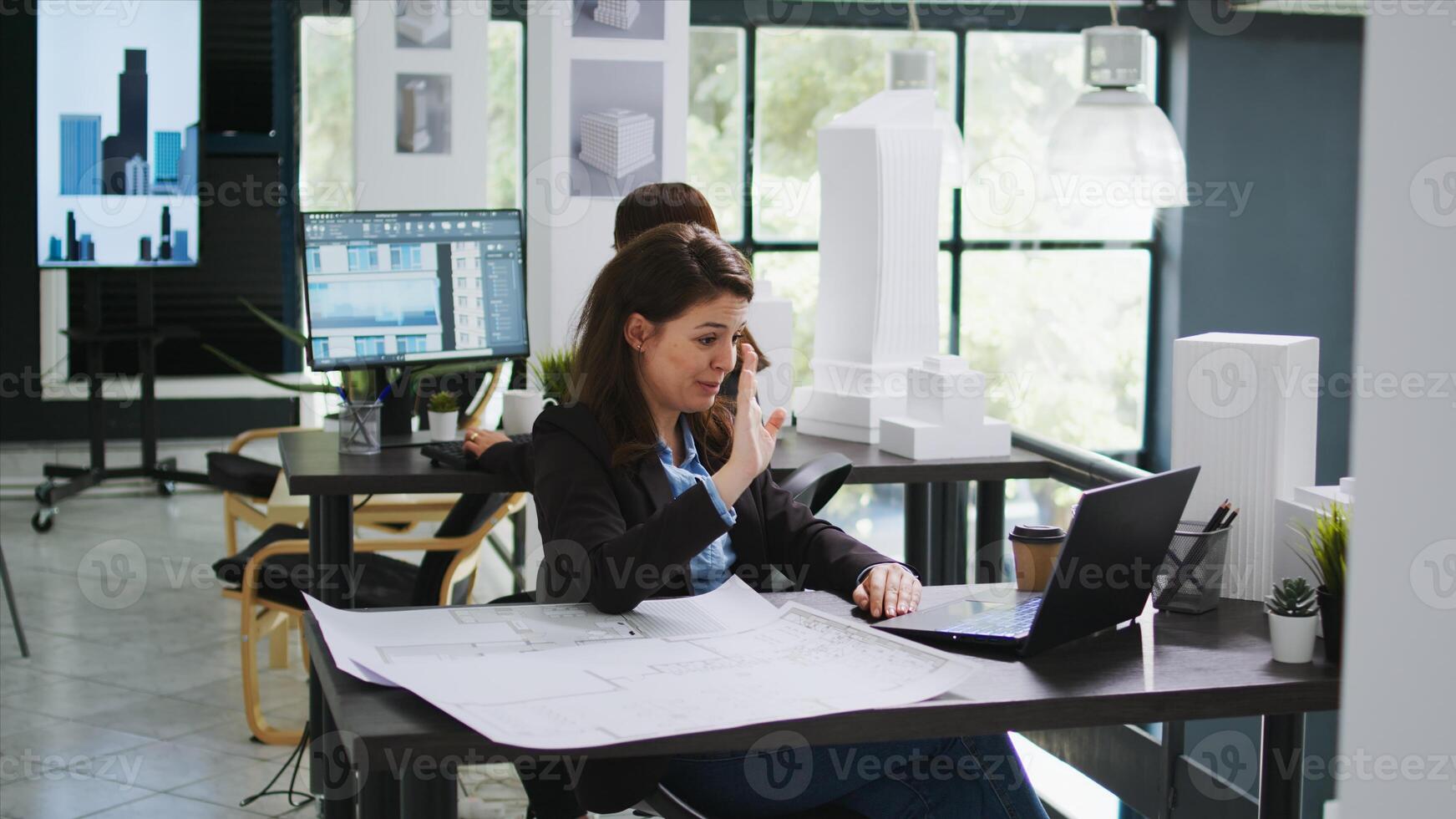 Sketch engineer meeting with contractor on videocall connection, discussing about scale measurements and draft elements before starting construction. Woman using online teleconference network. photo