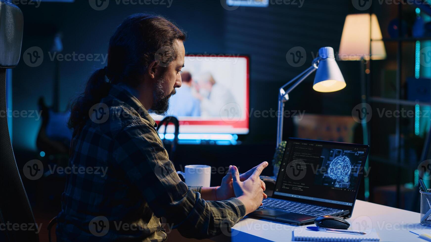 Programmer in living room office typing on keyboard, updating artificial intelligence neural networks, writing binary code scripts. Freelancing system administrator upgrading high tech AI photo
