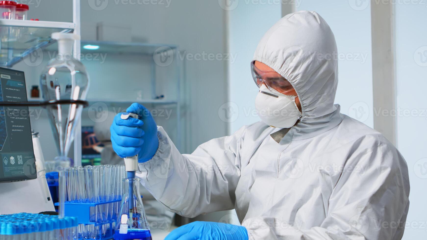 Laboratory scientist working in modern lab with test tubes and micropipette. Team of chemists examining virus evolution using high tech for scientific research of treatment development against covid19 photo