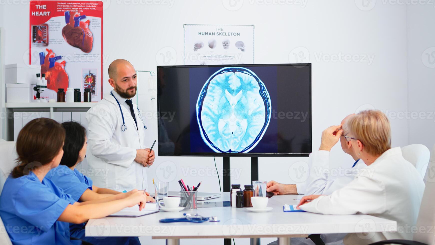 Team of doctors analysing digital x-ray and meeting together for sharing treatment ideas. Concept of brainstorming, meeting room, healthy and dashboard, analysing diagnosis of patients photo