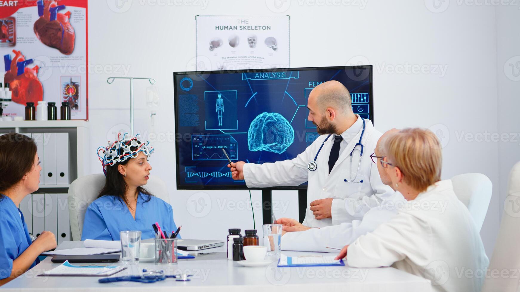 Team of doctors analysing brain functions using high tech in medical conference room, assistant testing new innovation. Medic studying diagnosis for treatment of patients working in hospital boardroom photo