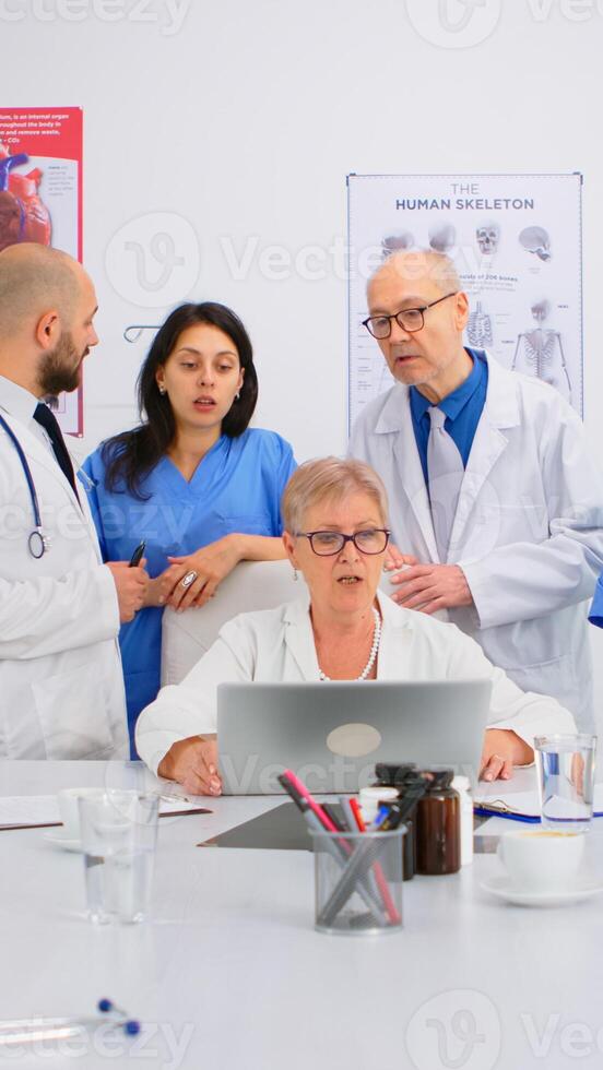 Brainstorming teamwork of physicians solving problem related to illnesses of patients in modern hospital conference room office. Medical examination, coworker consulting with mentor or chief physician photo