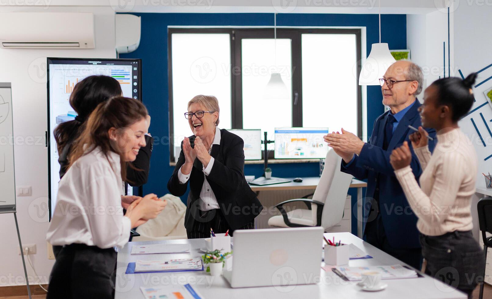 Happy diverse colleagues with new business opportunity enjoing victory. Multiethnical partners coworkers celebrate successful teamwork result at company briefing photo