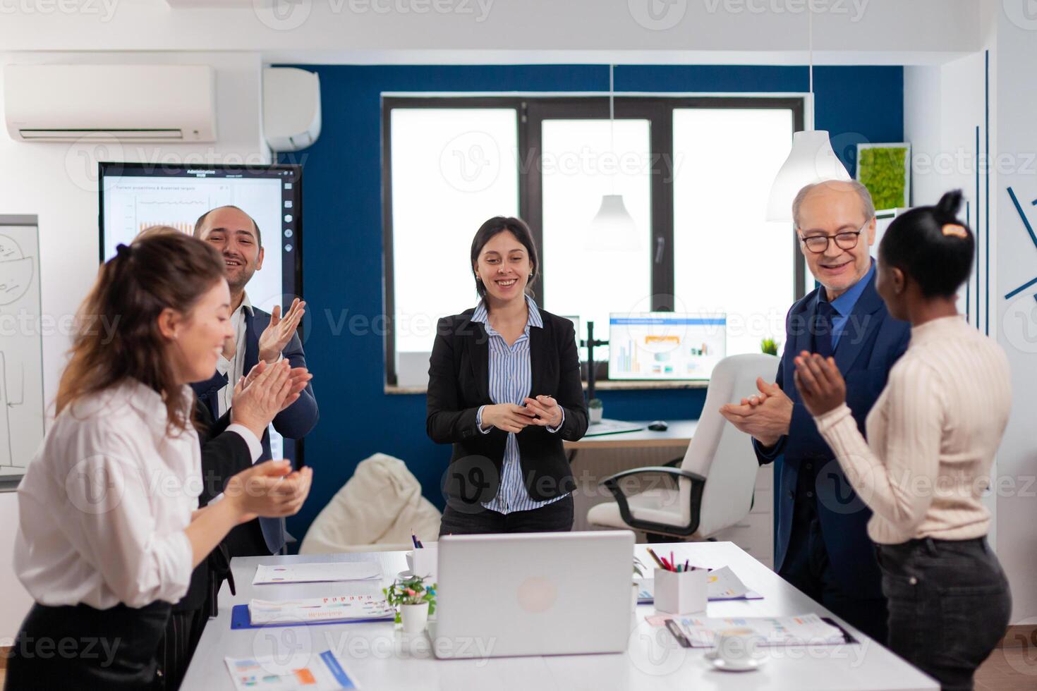 Happy creative business team having meeting in broadroom office victory overjoyed. Multiethnical partners coworkers celebrate successful teamwork result at company briefing photo