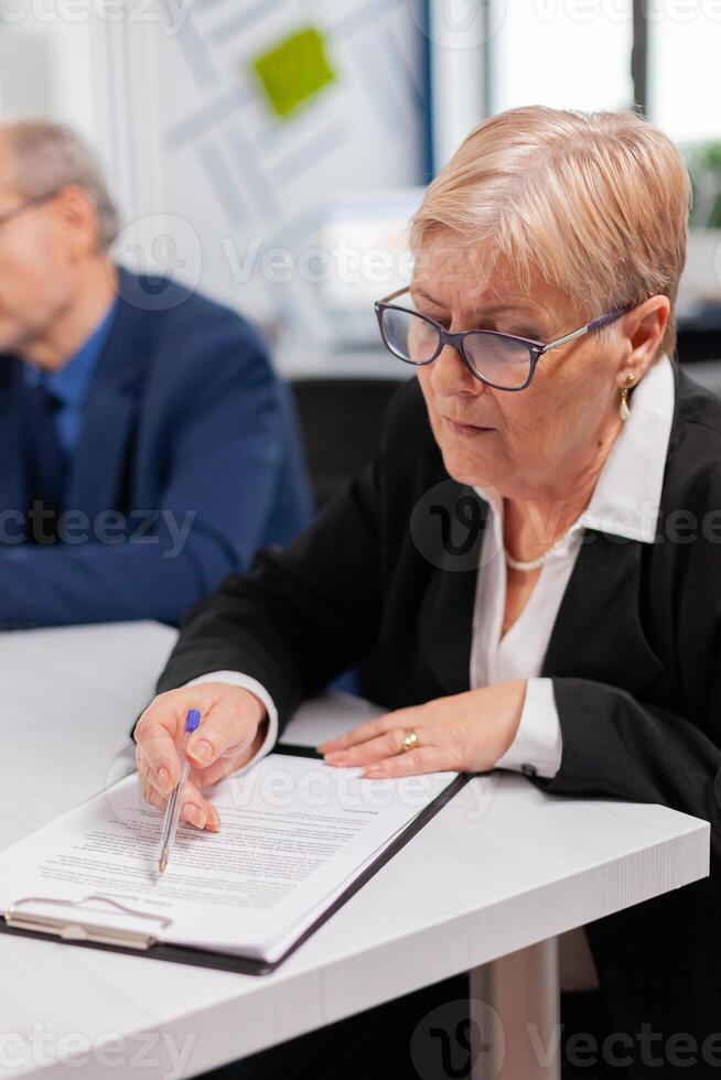 Busiess partners discussing new project for company evolution, senior manager woman checking tasks. Executive director meeting shareholders in start up office, making satisfactorily agreement. photo
