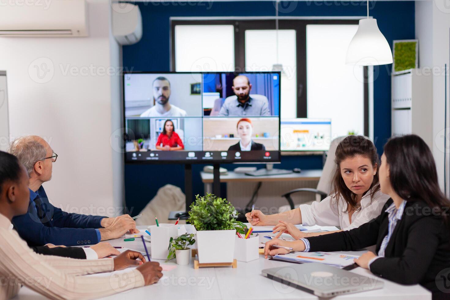 Emplyees workers having webcam group conference with coworkers speaking on call. Business people talking to webcam, do online conference participate internet brainstorming, distance office discussion. photo