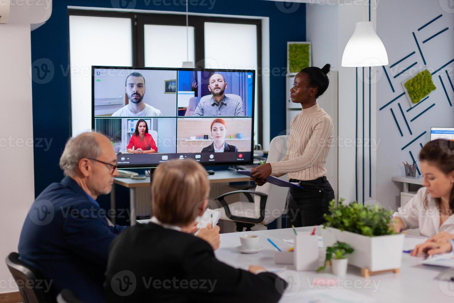 African woman discussing with remote managers on call presenting new partners on webcam. Business people talking to webcam, do online conference participate internet brainstorming, distance office discussion. photo