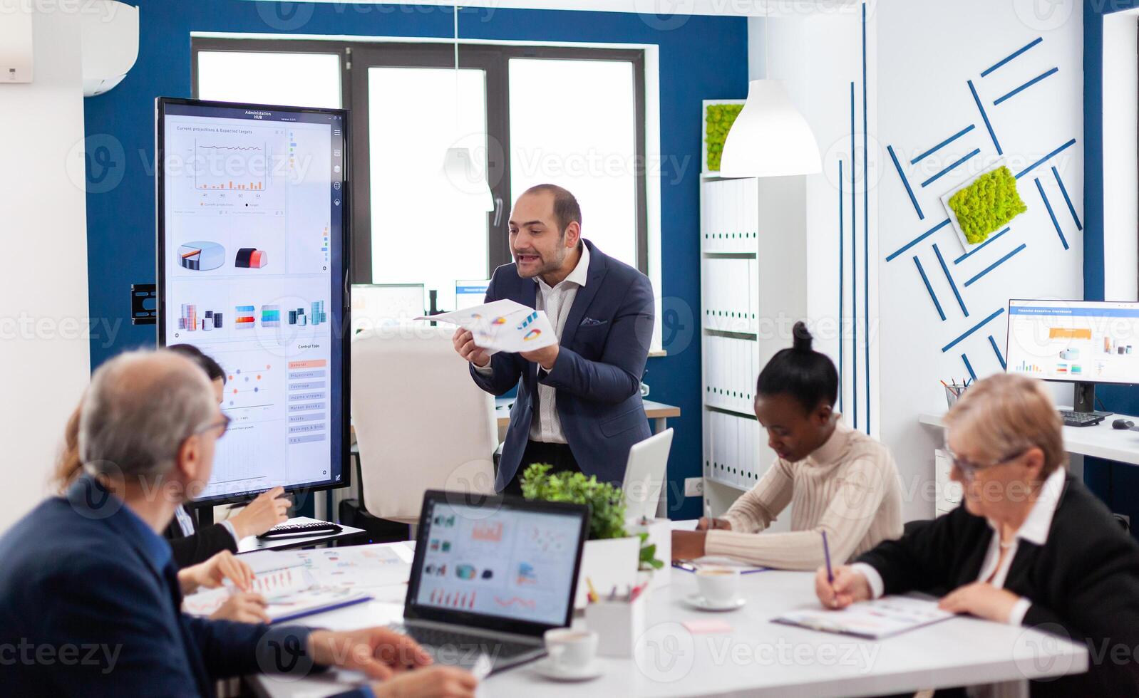 Angry screaming executive corporate in conference meeting room because of financial problem in meeting room. Reprimanding unsuccessful results and rivalry concept. photo