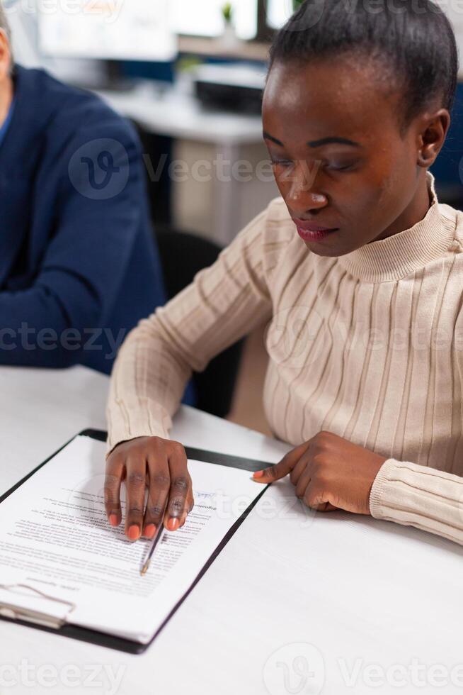 Start up team meeting with company leader planning financial strategy, analysing reports sharing paperwork. Executive director meeting shareholders in start up office, making satisfactorily agreement. photo