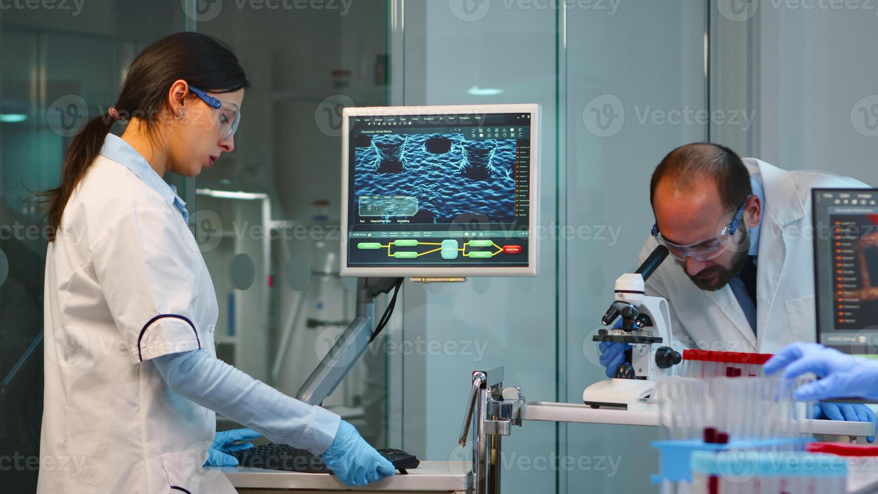 Scientist team checking virus development using microscope and nurse writing analysis results on computer overwork in modern equipped lab. Examining vaccine evolution using high tech for research. photo