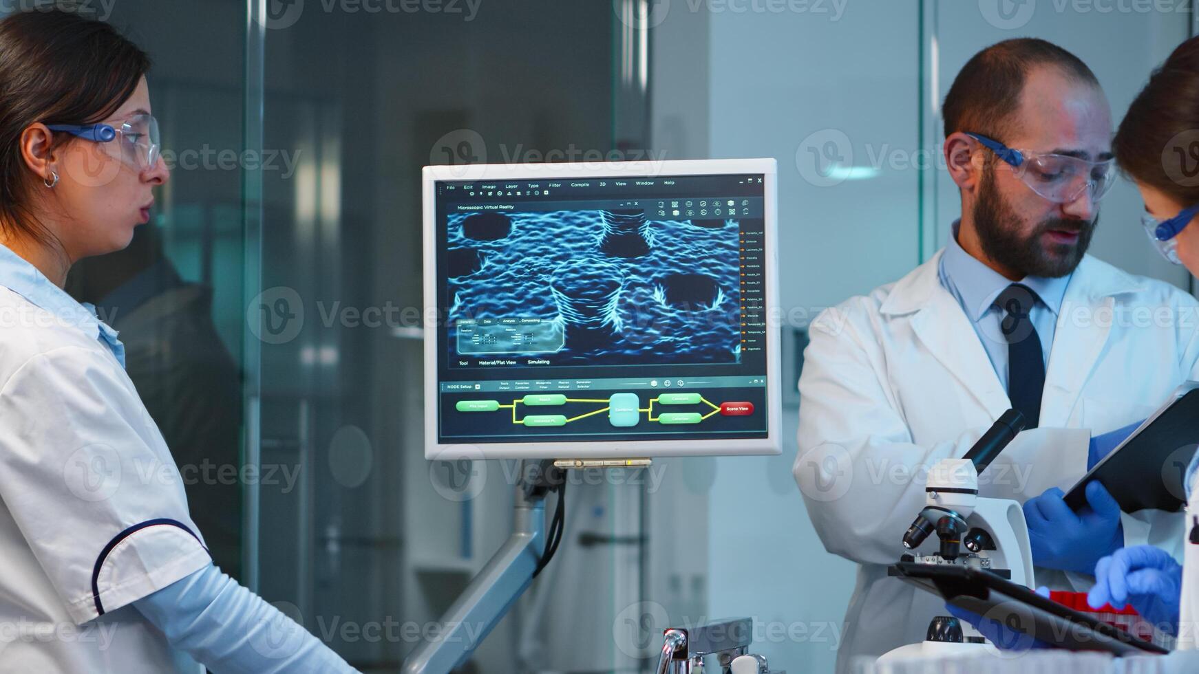 Group of researchers checking virus evolution conducting vaccine development with help of high tech, analysing results and planning next steps working late at night in modern equipped laboratory photo