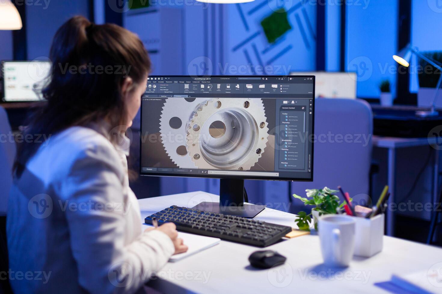 Woman engineer working on new digital prototype using professional construction equipment late at night at office company. Entrepreneur looking at technical architecture before deadline photo