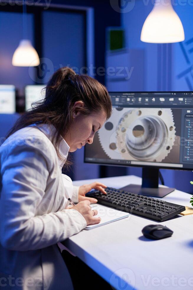Woman engineer architect working in modern cad program sitting at desk in start-up business office. Industrial employee start new prototype idea on computer using inovative design concept photo