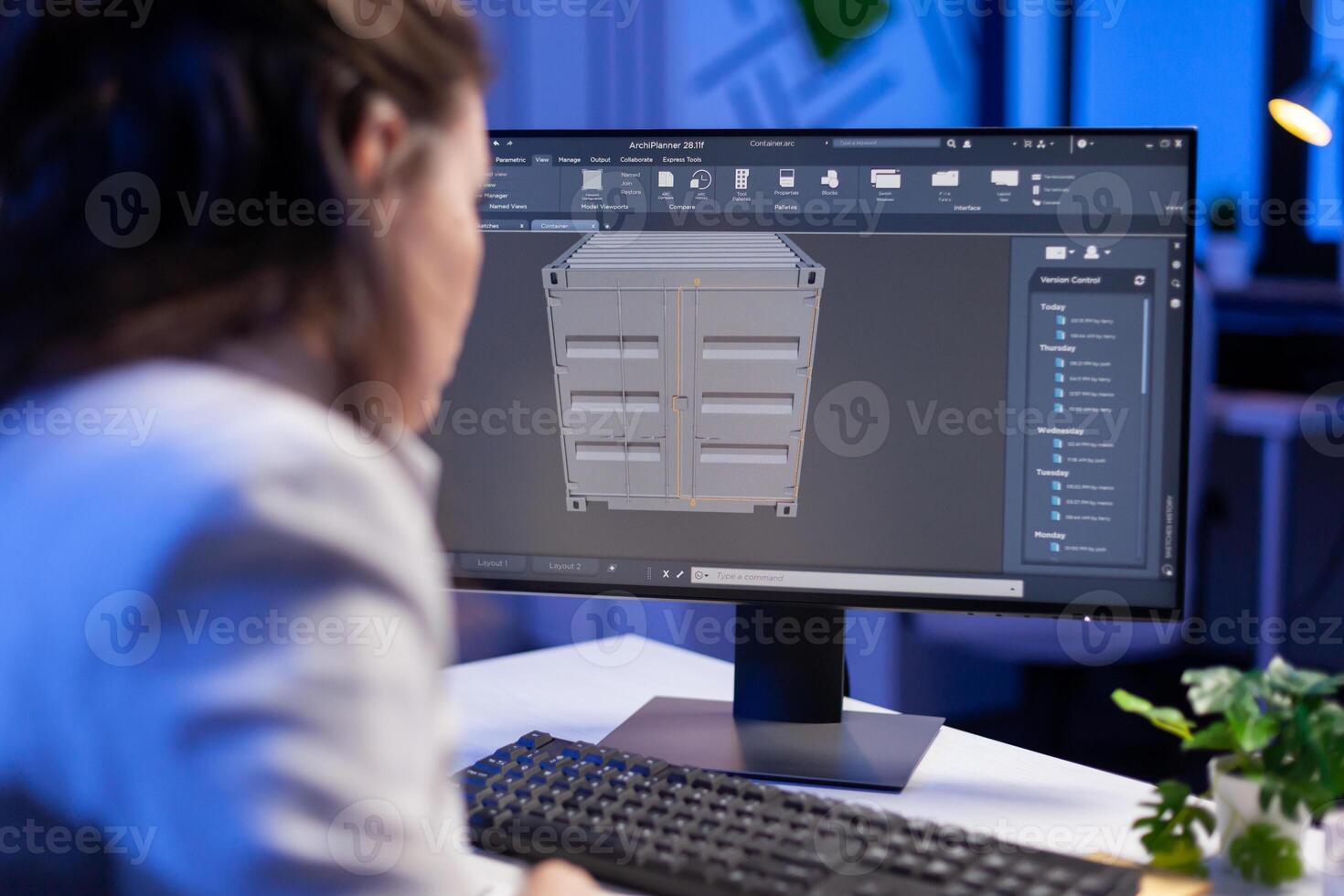 Engineer looking at cad software 3D prototype design concept of container working overtime in construction company. Overworked woman studying in office new project model using innovative technology photo