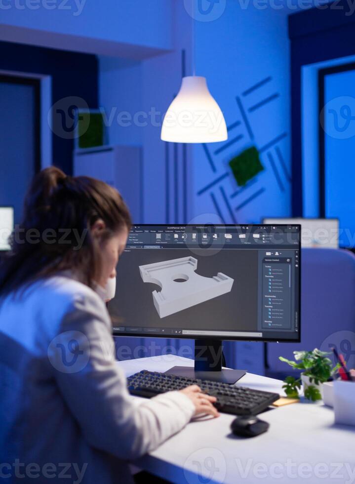 Software engineer working at digital cad project late at night in office company. Woman entrepreneur looking at technical construction before deadline using modern technology network photo