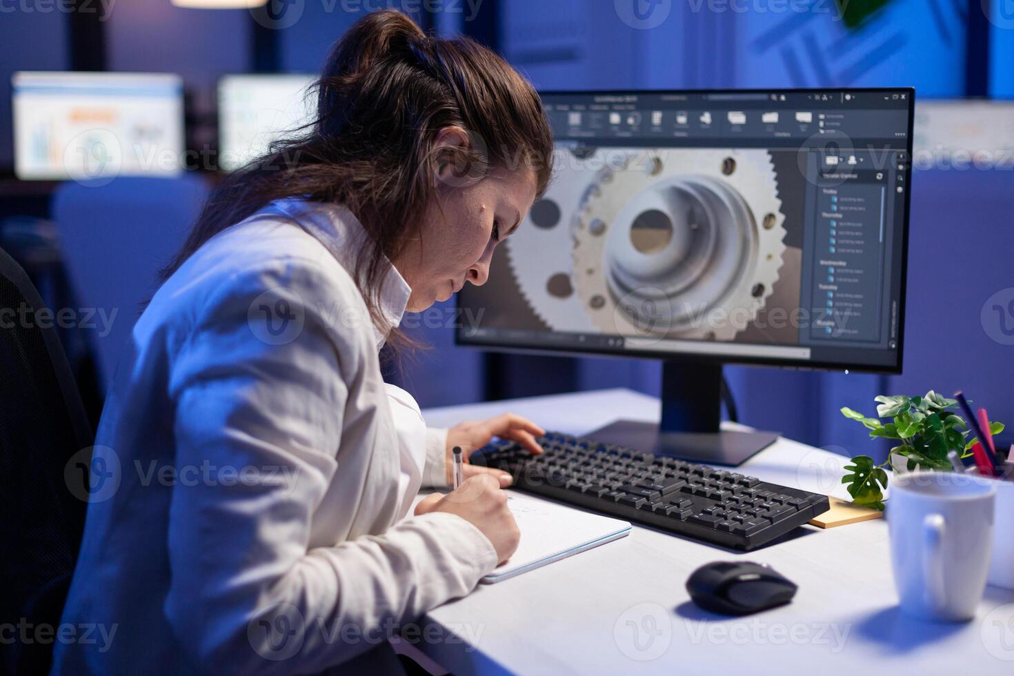 Woman engineer architect working in modern cad program sitting at desk in start-up business office. Industrial employee start new prototype idea on computer using inovative design concept photo