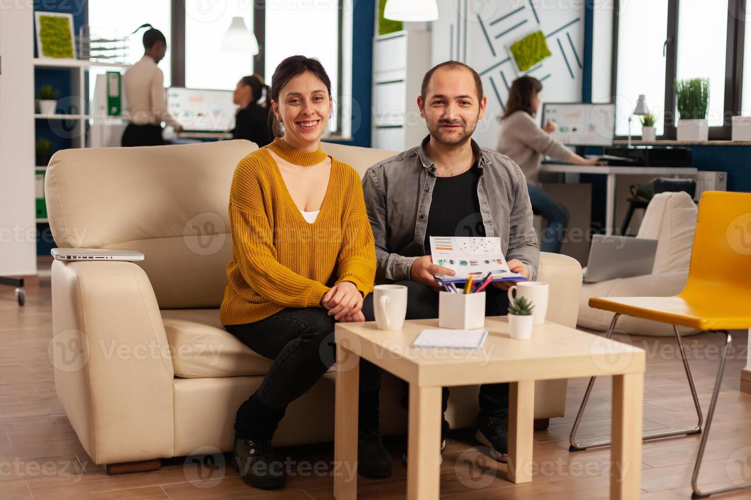 Start up company teamwork talking during meeting sitting on couch listening and explaning to remote manager team strategy. Multiethnic coworkers discussing about startup financial project. photo