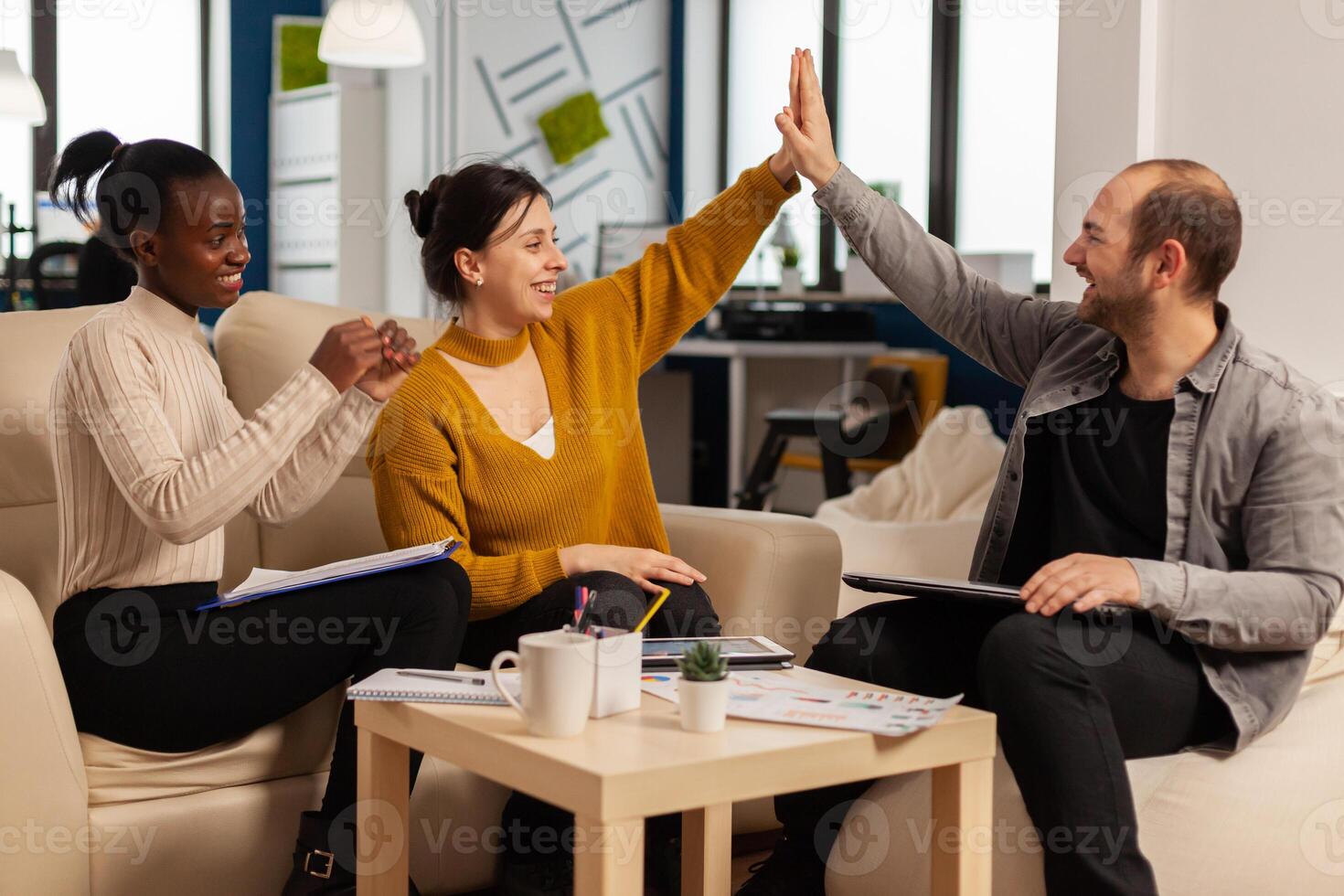 Happy leader motivate diverse employees business team give high five together, excited office workers group and coach engaged in teambuilding celebrate success good results reward in teamwork concept photo