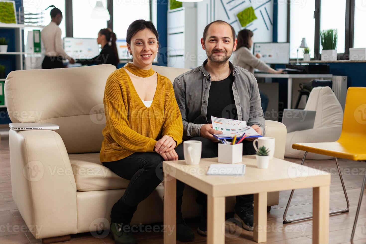 Start up company teamwork talking during meeting sitting on couch listening and explaning to remote manager team strategy. Multiethnic coworkers discussing about startup financial project. photo