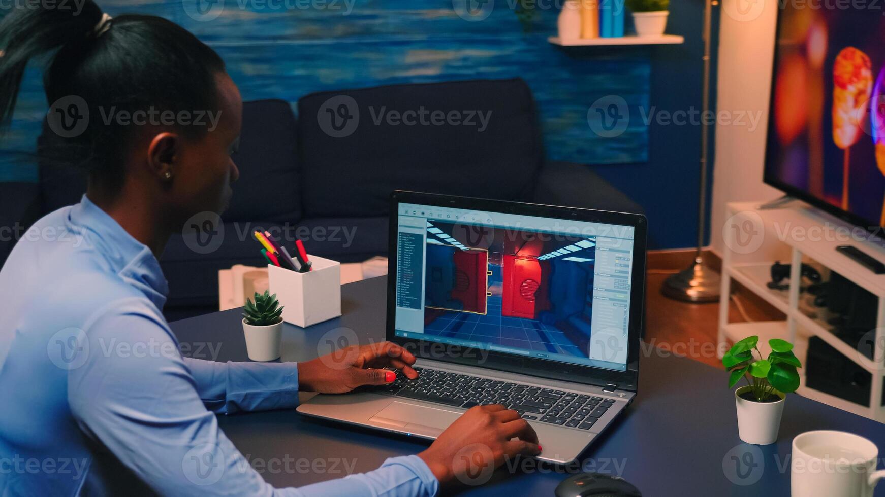 Young african woman gamer testing online professional game on laptop at home late at night. Professional player checking digital games on her computer with modern technology network wireless. photo