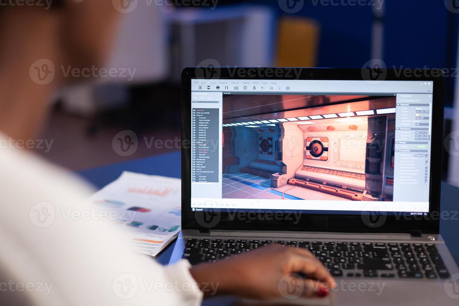 Black freelancer game developer typing on keyboard developing new level of videogame. African pro player testing game over level interface in midnight from business office using laptop. photo