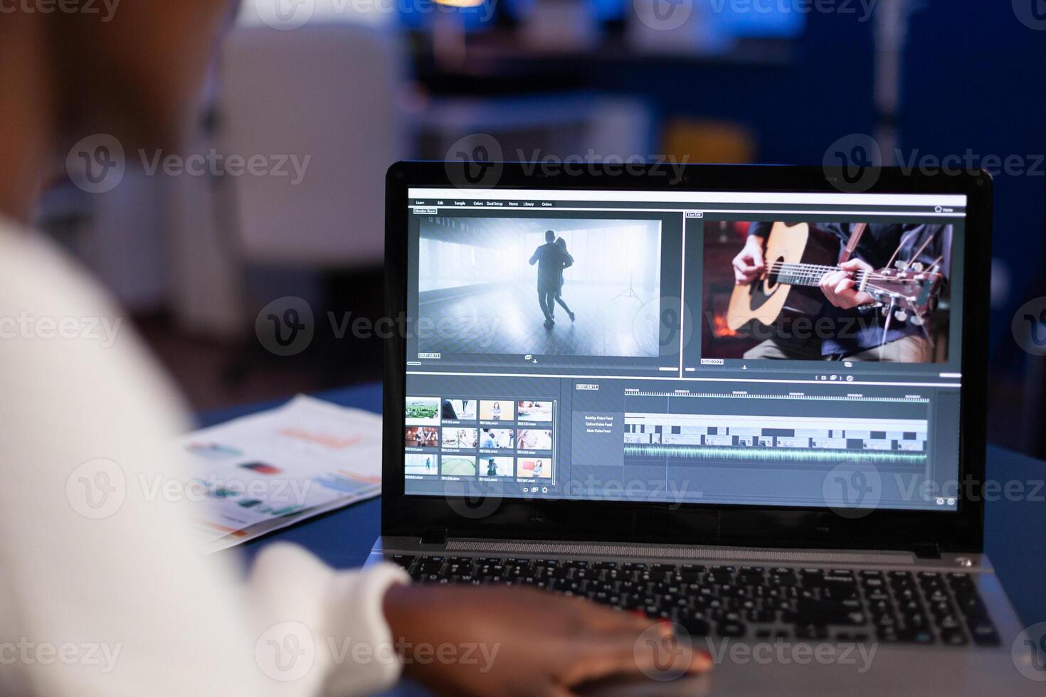 African american woman editor working at creativity film montage sitting in modern agency office. Content creator in digital multimedia company processing movie with post production software photo