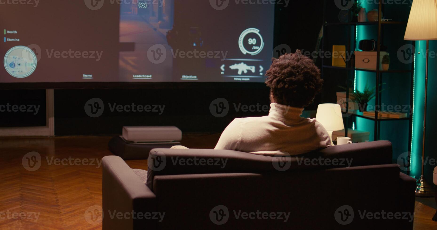 Man playing shooter videogame on TV with gun shooting laser bullets at flying robots in dark atmospheric industrial setting. Gamer enjoying competitive PvP fps internet multiplayer tournament game photo