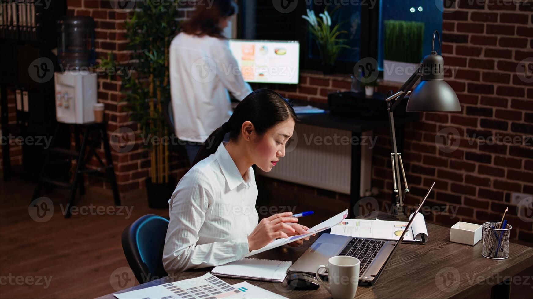 Employee writing important emails at computer desk, finalizing deal with business associates. Businesswoman doing b2b networking over internet with prospecting clients, typing on laptop photo