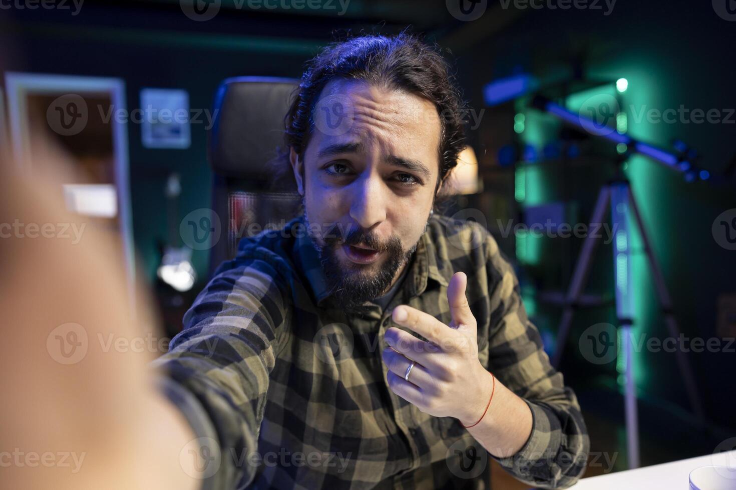 POV of a bearded man creating content for his social media vlog. Young male influencer passionately speaking to the camera, sharing his thoughts and experiences with his audience. photo
