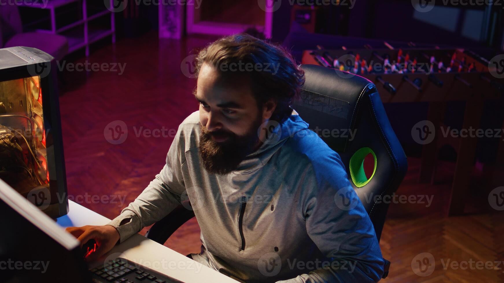 Man plays intense videogame tournament online during stream with audience, struggling to beat opponent. Impatient gamer feeling stressed while participating in esports competition during livestream photo