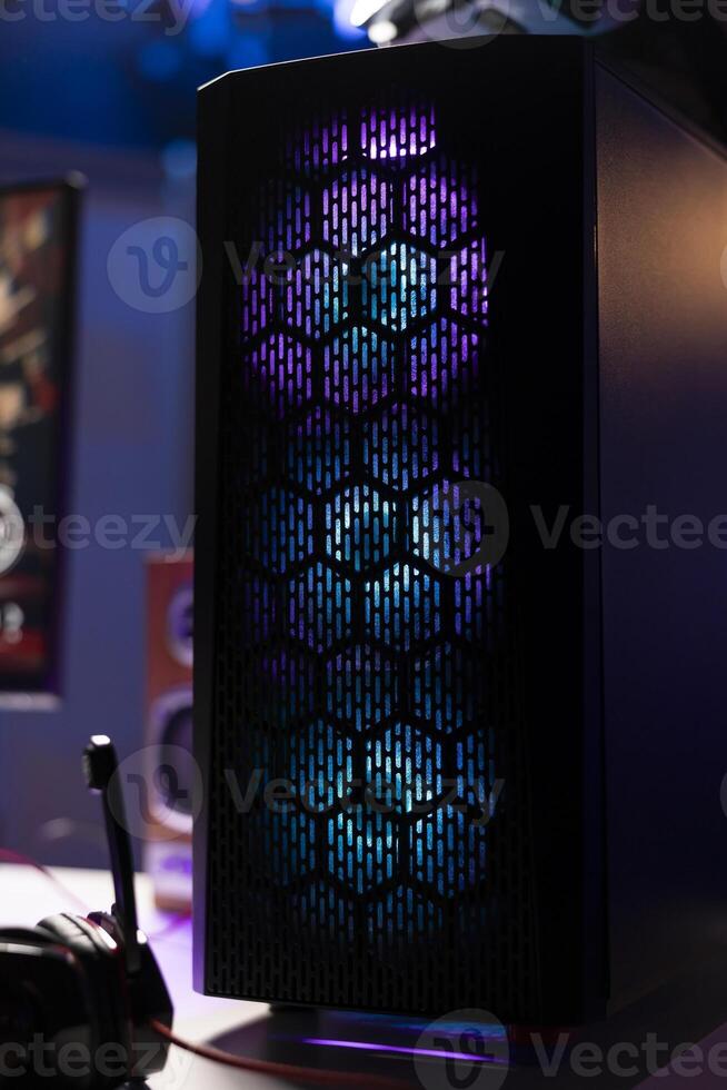 RGB lights illuminated fans on gaming computer capable of playing latest games, close up shot, empty apartment. Focus of components on powerful desktop PC in home living room photo