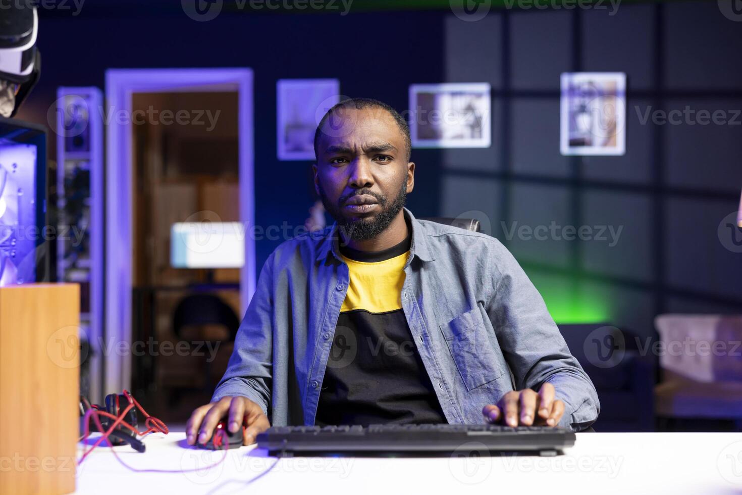 Gamer struggling to defeat opponents while playing esports tournament, unhappy with his performance. Upset player losing while competing in multiplayer videogame, showing frustration photo